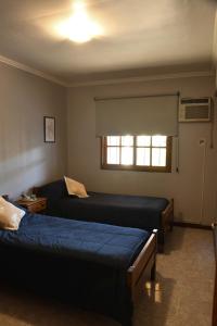 a bedroom with two beds and a window at Casa capital in San Juan