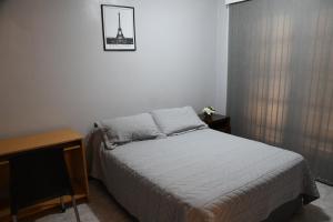 a small bedroom with a bed and a television at Casa capital in San Juan