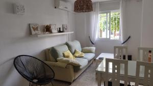 a living room with a couch and a glass table at URBION HOME in Seville