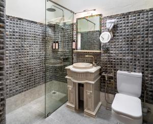 a bathroom with a toilet and a sink and a shower at Kazma Boutique Hotel in Tbilisi City