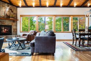 a living room filled with furniture and a fireplace at Strasse Ski Chalet Hot Tub Dog-Friendly Skiing in Bartlett
