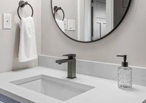 a white bathroom with a sink and a mirror at Escape From Life in Bedeque +26 photos