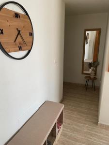 a clock hanging on a wall in a room at Apartamento Ro & Vi in Águilas