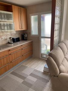 a living room with a couch and a kitchen at Apartamento Ro & Vi in Águilas +39 photos