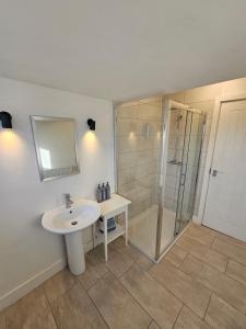 a bathroom with a sink and a shower at Market Quarter Apartment, town centre, free parking and wifi in Southport