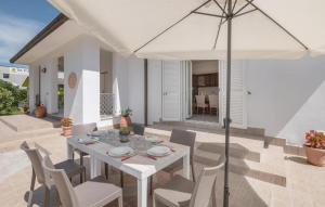 a white table and chairs with an umbrella on a patio at villa pia in Piumarola