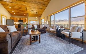 a living room with a couch and a table at The Yellowstone - Spacious Wapiti Valley Cabin with Stunning Views! in Wapiti