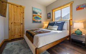 a bedroom with a bed and a window at The Yellowstone - Spacious Wapiti Valley Cabin with Stunning Views! in Wapiti