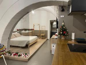 a room with a bed and a christmas tree in it at Archome Luxury Apartment in Brindisi