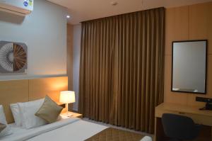 Postel nebo postele na pokoji v ubytování JBR Residency