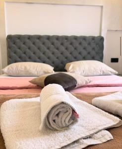 a bedroom with two beds with towels on them at Gas Otel in Belgrade