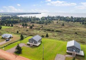 an aerial view of two houses on a grassy field at The Perfect Getaway in Bedeque