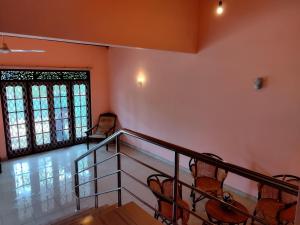a room with a staircase with chairs and a window at Golden Glade in Weligama +22 photos