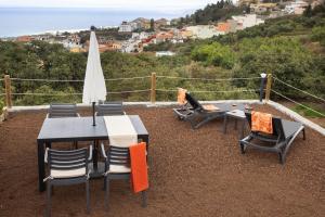 a table and chairs and an umbrella on a roof at Casita Albornoz in Los Realejos