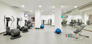a gym with several treadmills and exercise machines at Sol Principe in Torremolinos