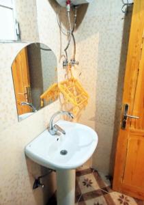 a bathroom with a white sink and a mirror at Ibiza Guest House in Aswan