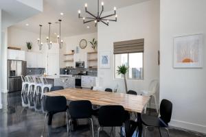 a kitchen and dining room with a wooden table and chairs at Azure Abode at Sand Hollow Resort in Hurricane