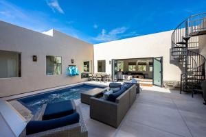 a living room with a swimming pool and a house at Azure Abode at Sand Hollow Resort in Hurricane