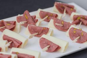 a plate of ham and cheese sandwiches on skewers at Restway Hotel in Izmir