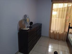 a bedroom with a dresser with a fan on it at Casa huéspedes Noe in Coronado