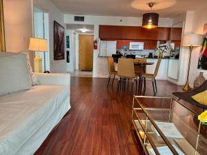 a living room and kitchen with a couch and a table at Brickell Miami Unit, Amazing view, balcony, Pool, 1 free Parking in Miami