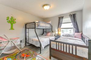 a bedroom with two bunk beds and a window at 4 Mi to Dtwn Family Home in Buffalo in Buffalo