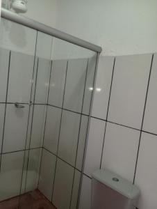 a bathroom with a shower and a toilet at Apartamento e suítes Itacaré in Itacaré