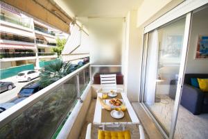 a balcony with a table with food on it at Le Studio Cannois Standing Presta in Cannes