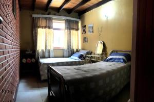 a living room with a bed and a couch at Hermosa Casa Familiar in Tarija