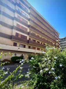 a tall building with flowers in front of it at La Roma di Camilla in Rome