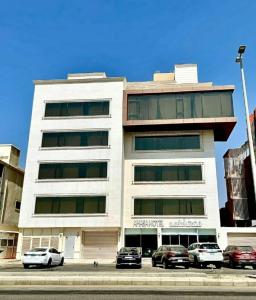 a building with cars parked in front of it at شقق فيدا حي المحمدية in Jeddah