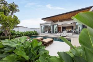 an exterior view of a villa with a swimming pool at Luxury 3BR Villa Eden with Private Pool by TropicLook in Ban Pak Lak