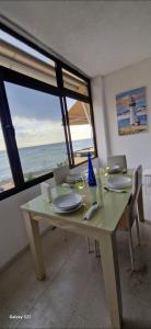a dining room with a table with a view of the ocean at Lanzarote Playa y Mar in Arrecife