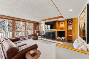 a living room with a couch and a fireplace at Decatur 1785 by Summit County Mountain Retreats in Keystone