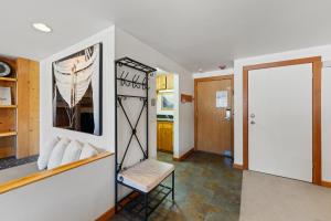 a living room with a chair and a mirror at Decatur 1785 by Summit County Mountain Retreats in Keystone