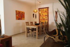 a dining room with a table and chairs at Casa Africana in Vila Nova de Milfontes