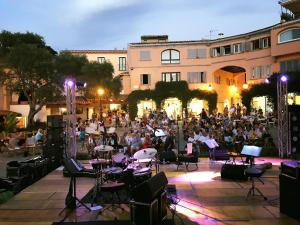 a large group of people sitting around a concert at Residence Bouganville in Porto Rotondo +48 photos