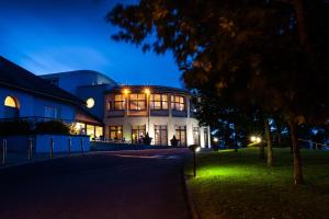 a large building at night with its lights on at Ballyroe Lodge in Tralee