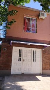 a house with a white garage door and a window at Tesoro Escondido in Santa Rosa