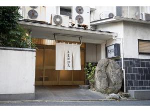 a building with a door with a rock in front of it at SUIHOKAKU HOTEL - Vacation STAY 49740v in Fukuoka