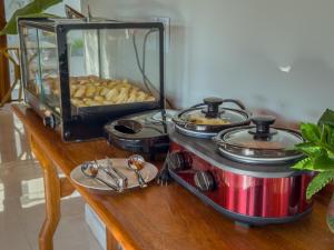 a counter with a stove with some food on it at Pousada Recanto Dourado in Bonito
