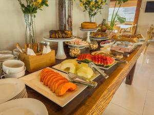 a buffet with sushi and other foods on a table at Pousada Recanto Dourado in Bonito