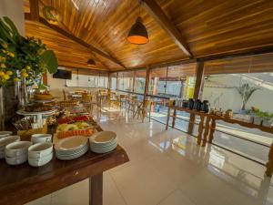 a kitchen with a table with plates of food on it at Pousada Recanto Dourado in Bonito