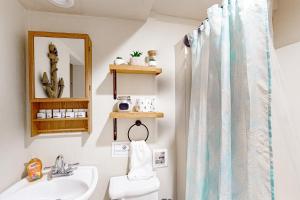 a bathroom with a sink and a shower curtain at Liberty Lodge in Mineral +35 photos