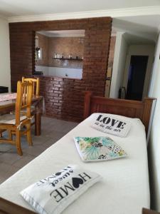 two beds in a room with a kitchen and a table at Tesoro Escondido in Santa Rosa