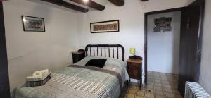 a bedroom with a bed and a nightstand and a bed sidx sidx sidx sidx at Can Manuel in Gabet