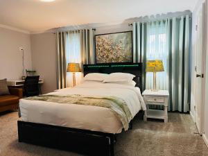 a bedroom with a large bed and a couch at Sherizee Home in Marblehead