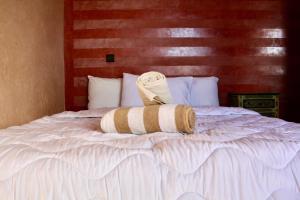 a bed with a towel on top of it at chillax see view terrace in Imsouane