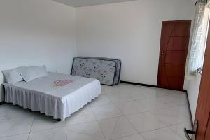 Postel nebo postele na pokoji v ubytování Casa de temporada Guriri com Piscina - Cod 34