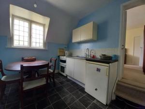 a kitchen with a wooden table and a table and a tableablish at Private 1-bedroom apartment in Raynes Park in Raynes Park